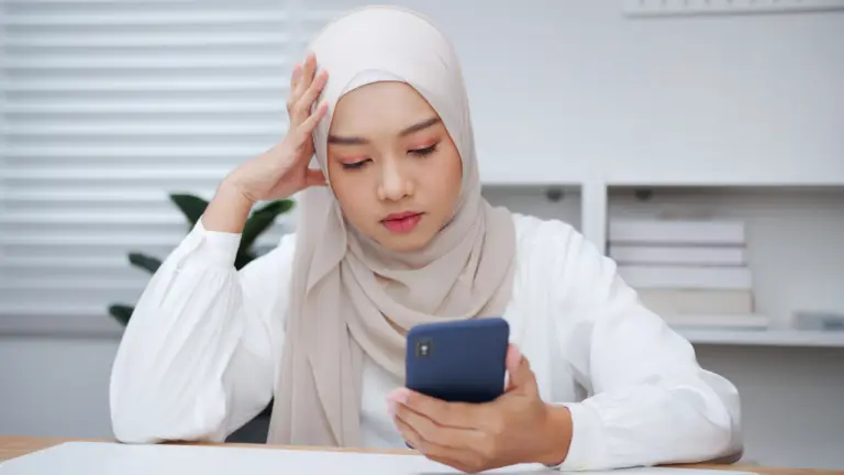 Woman in a desk looking ok but feeling tired